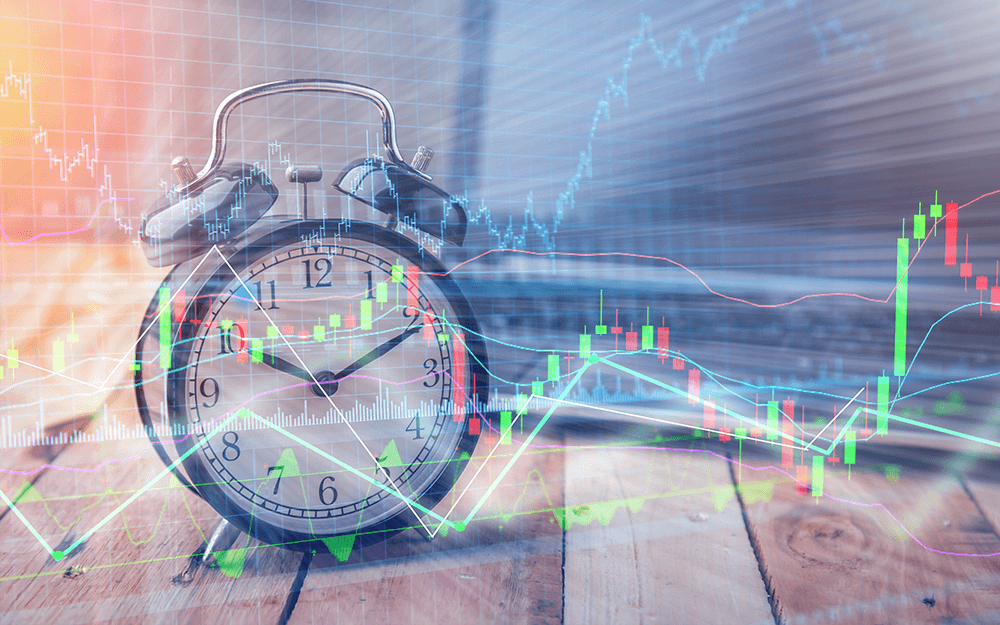 A clock used for time frames in trading, overlaid with financial graph candlesticks.